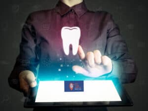 A digital image showing a man holding a tablet and clicking on tooth to symbolise SEO and digital marketing for dentists